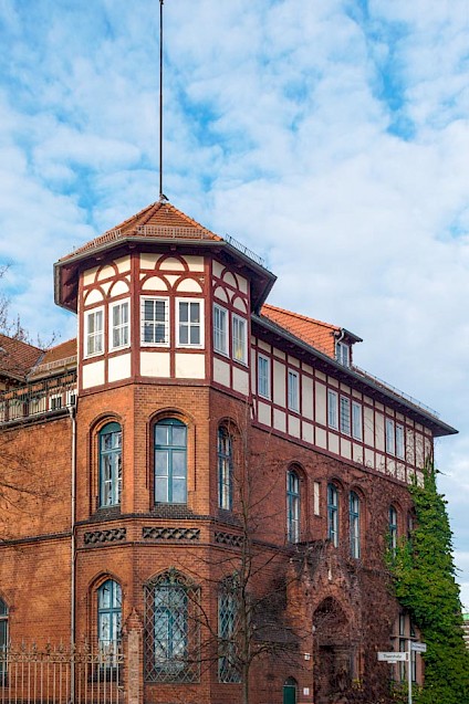 Die Front der Villa Heimat mit ihrem markanten Turm und den rot-braunen Ziegeln
